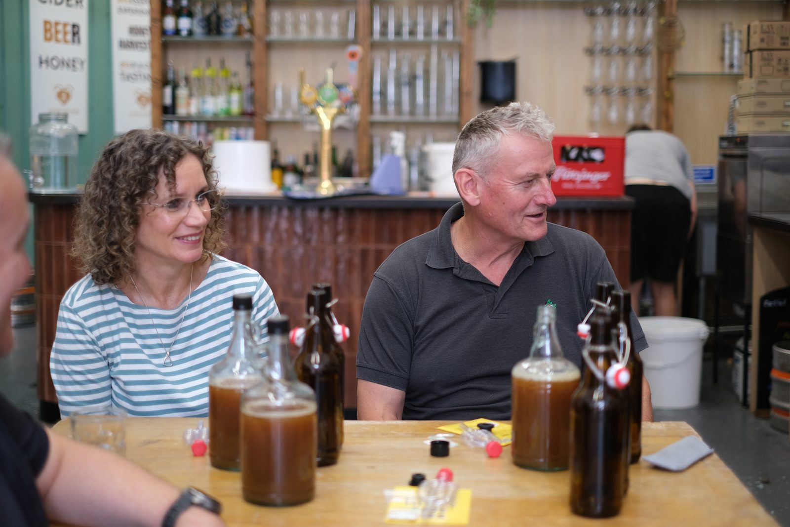 Guests with bottles of the cider they made