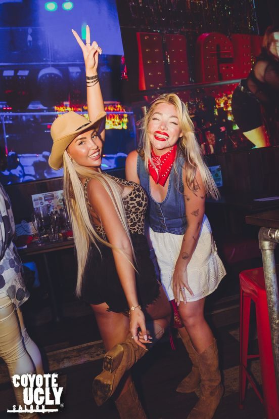 The Coyotes behind the bar at Coyote Ugly Saloon Camden